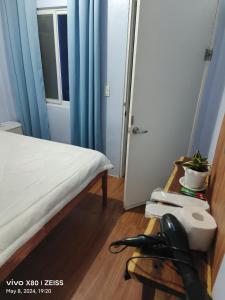 a room with a bed and a phone in a room at Ani Marie Guest House in Coron
