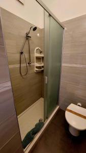 a shower with a glass door in a bathroom at Il Mirto E La Rosa in Arenella
