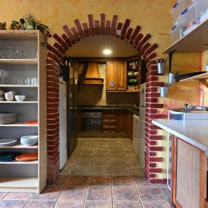 an archway in a kitchen with a brick wall at Hostel Los Amigos by Youroom in La Mareta