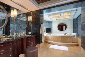 a bathroom with a tub and a large mirror at InterContinental Century City Chengdu, an IHG Hotel in Chengdu