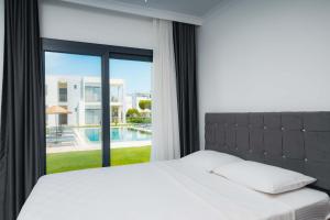 a bedroom with a bed and a large window at Ben Houses Family in Bodrum City +57 photos