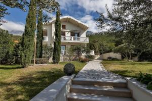 a house with a walkway in front of a yard at Villa Markota!200m from the SEA! in Promajna