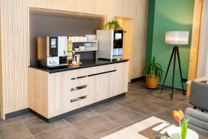 a kitchen with a counter with a refrigerator at Zum Lenz in Langau