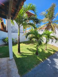 un patio con palmeras frente a una casa en Casa no atalaia na rua atalho, en Salinópolis