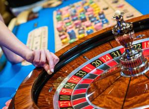 a person playing roulette on a casino roulette wheel at Cratos Premium Hotel Casino & SPA in Kyrenia