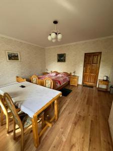 a room with a table and a bed in it at Dom Gościnny BIEGUN in Jedlina-Zdrój