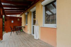 a balcony with a table and chairs and a window at Six Corners Sunny Corner Apartment with Terrace in Pécs +12 photos