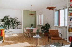 a living room with a table and chairs and plants at Punta Penna Seahouse in Vasto