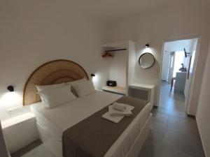 a bedroom with a bed with a plate on it at Maria's Garden in Antiparos