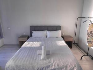 a bedroom with a large bed with two night stands at SUNRISE JESSELTON QUAY NEAR SURIA GAYA STREET Jesselton Point in Kota Kinabalu