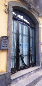 a window with a black iron gate on a building at A Trecastagni - Etna Home in Trecastagni