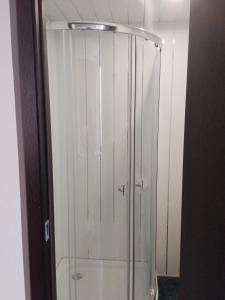 a shower with a glass door in a bathroom at Dava in Gyumri