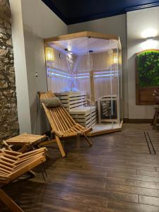 a room with two chairs and a glass case at Apartament Baron II ***** in Jelenia Góra