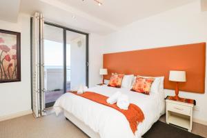 a bedroom with a large bed and a large window at 506 Hibernian Towers Luxury Self Catering Apartment Strand Cape Town South Africa in Cape Town +18 photos