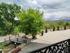 a view of a park with a tree and benches at Boyuk Ashirim Hotel in Ganja