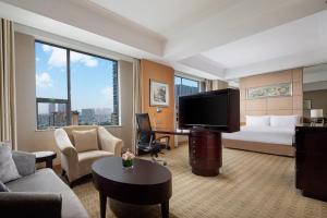 a hotel room with a bed and a flat screen tv at Holiday Inn Chengdu Century City - East, an IHG Hotel in Chengdu