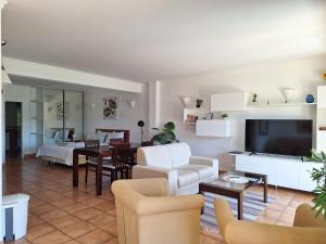 a living room with a couch and a dining room at Amazing Studio with Ocean View, Pool and Beach in Lagos