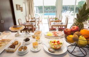 فندق بوتيك وسبا فيلا إسيدرو في سان إيسيدرو: طاولة عليها العديد من أطباق الطعام