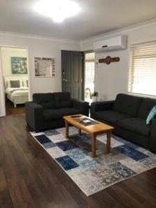 a living room with a couch and a coffee table at Bronte Lodge, Wine Country Farm Stay Hunter Valley with Games Room, Close to Town in Greta Main +27 photos