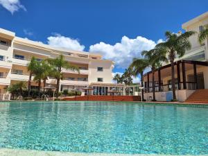 a swimming pool in front of a building at Amazing Studio with Ocean View, Pool and Beach in Lagos