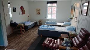 Habitación con 2 camas y sofá en Danhostel Sønderborg Vollerup, en Sønderborg