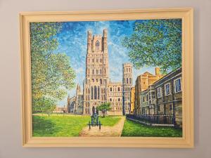 a painting of a building with a clock tower at The Old Hay Store, Ely in Ely