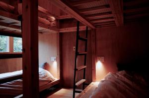 a bedroom with two bunk beds and a ladder at MAGATAMA,INN - Vacation STAY 85473v in Sumoto