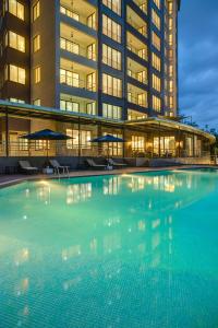 a large swimming pool in front of a building at GemSuites Riverside in Nairobi