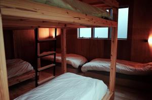 a bunk bed room with three bunk beds in it at MAGATAMA,INN - Vacation STAY 41790v in Sumoto