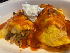 a white plate of food with food on it at Creole Dame Bed & Breakfast Inn in Sumter