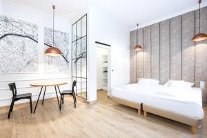a bedroom with a bed and a table and chairs at Europejski Boutique Hotel in Radom