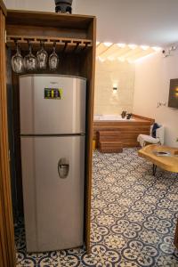 a refrigerator in the middle of a room with a couch at Eco Apartamento Crudo in Jardin