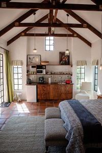 a large room with a bed and a kitchen at Boerfontein in Windmeul