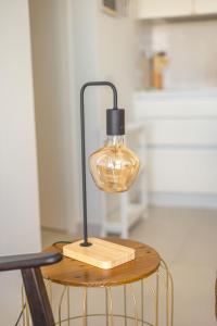 een glazen lamp op een tafel met een stoel bij Casas do Forte Sun 4pax by Portugal Hideaway in Cabanas de Tavira