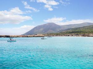 three boats in the water with mountains in the background at Azzurro Holiday Villas in Peyia