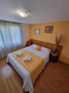 a bedroom with a large bed with two towels on it at Casa Maru in Jurilovca