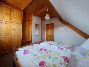 a bedroom with a large bed with flowers on it at Ferienwohnung Sauer in Pfofeld