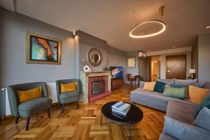 Acropolis Compass Residence في أثينا: غرفة معيشة مع أريكة ومدفأة