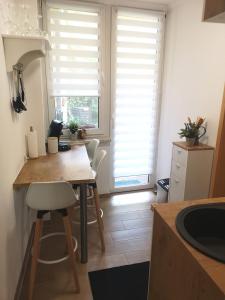 cocina con mesa, sillas y ventana en Gemütliche Ferienwohnung en Torgau