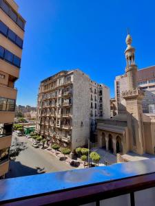 a view from a balcony of a building and a mosque at City View Palace hotel in Cairo