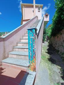 un conjunto de escaleras con un mural en el lateral en B&B Il Girasole en Finale Ligure