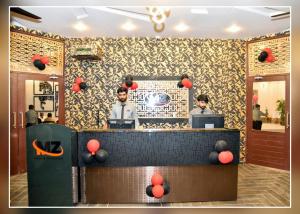 two men standing at the counter of a restaurant at MZ Hotel and Restaurant Sukkur in Kalar Goth
