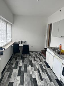 an empty kitchen with two chairs and a table at Ferienwohnung-Monteurwohnung in Homburg