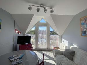 a living room with a couch and a table at Appartement vue mer avec parking privé et WiFi à Perros-Guirec - FR-1-542-60 in Perros-Guirec