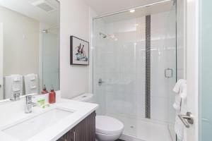 a bathroom with a shower and a toilet and a sink at Sunlit Urban Charm In Old Town Victoria in Victoria +19 photos