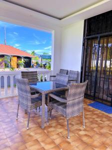 a dining room with a table and chairs on a patio at Villa Ella in Mombasa