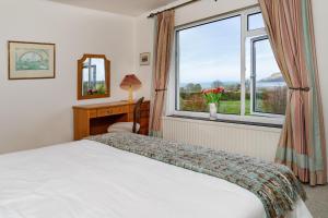 a bedroom with a bed and a window at Dolawel Newport, Pembrokeshire in Newport Pembrokeshire
