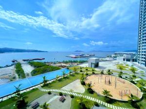 an aerial view of a resort with a pool and the ocean at SUNRISE JESSELTON QUAY NEAR SURIA GAYA STREET Jesselton Point in Kota Kinabalu