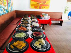 a row of plates of food on a table at Hotel Pousada Salvador Paradise in Lauro de Freitas