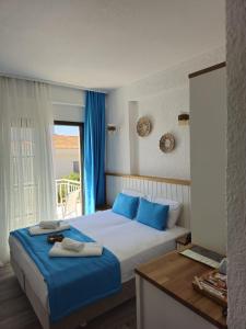 切什梅Bahar Butik Otel的一间卧室配有一张带蓝色枕头的大床